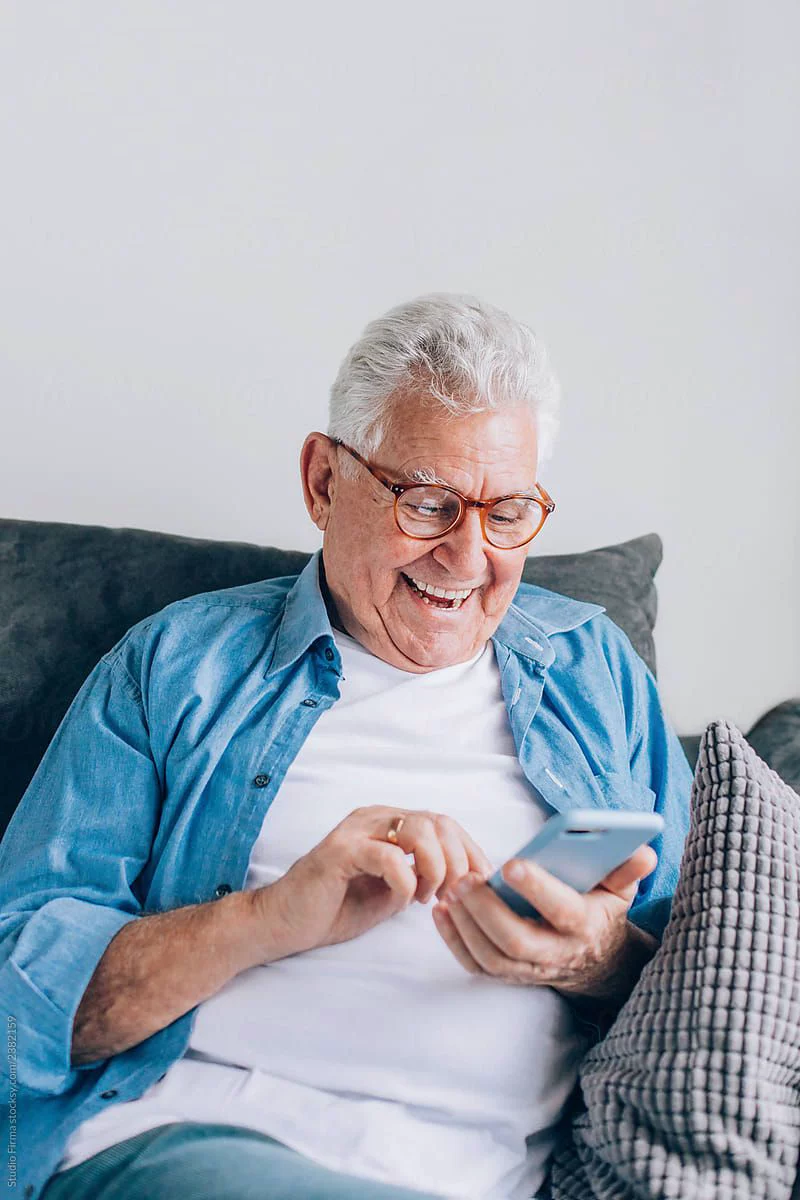 A member taking a call from his sofa , reachable wherever life takes them