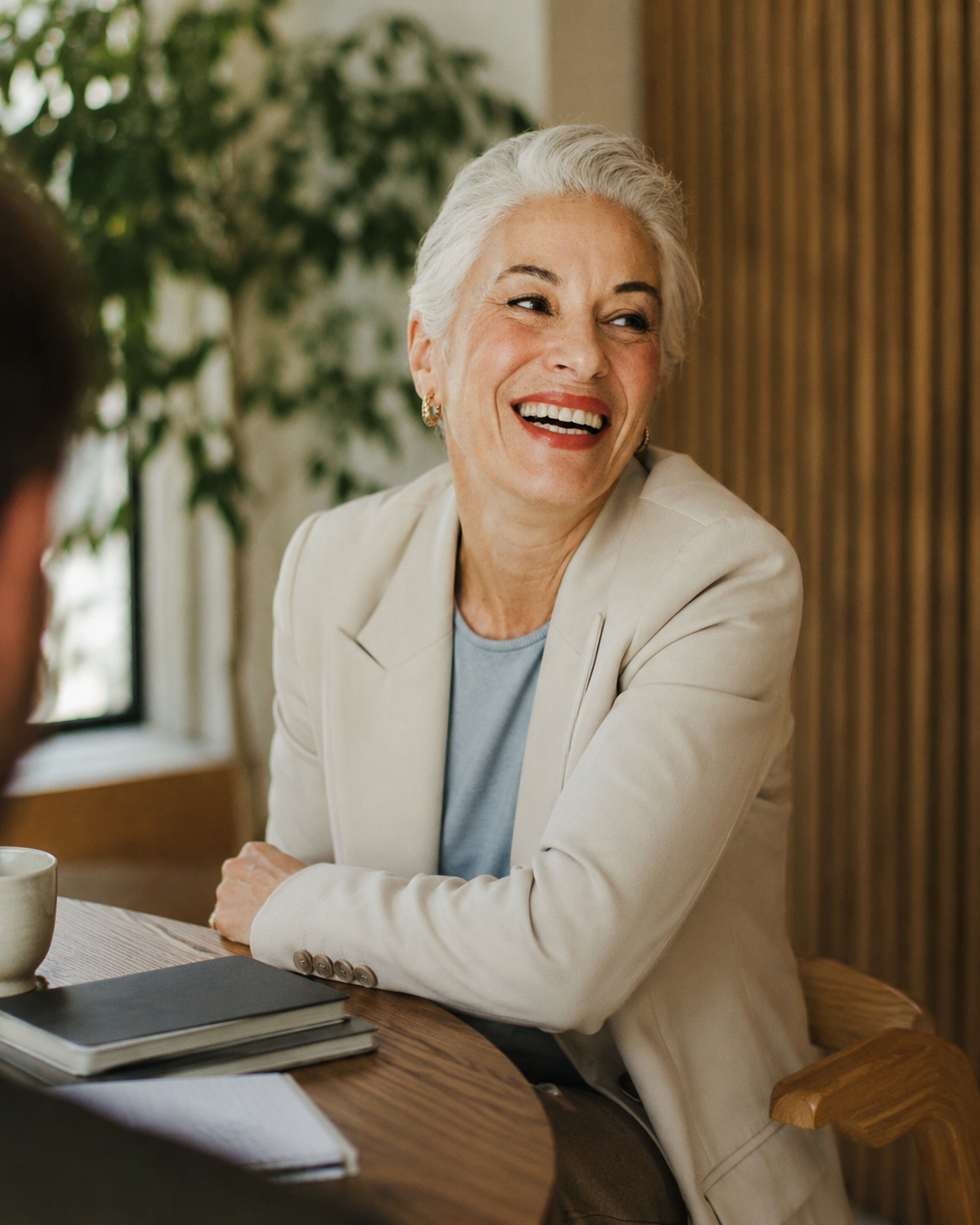 A relaxed leader smiling during a one-to-one conversation