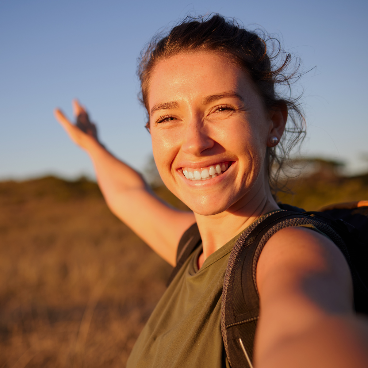 A confident woman outdoors , free and at ease
